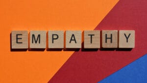 The word 'Empathy' spelled out in blocks with a colorful background.