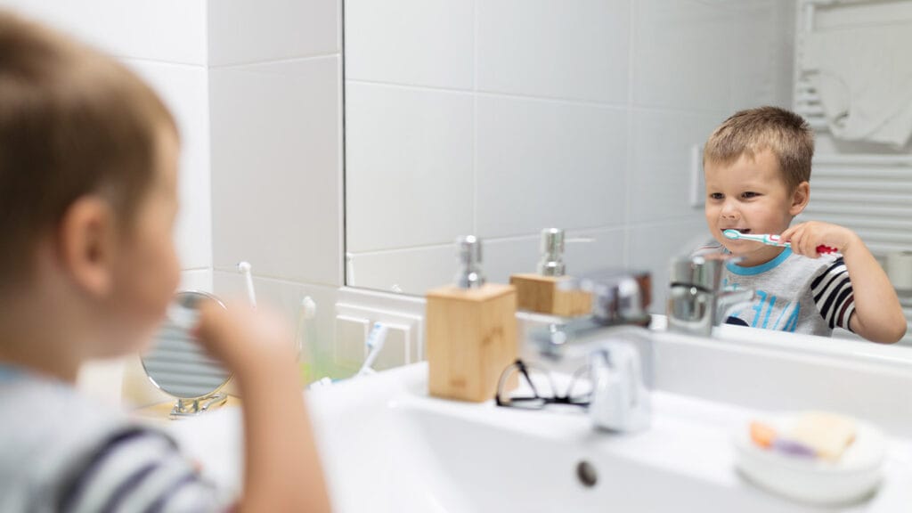 A little by brushes his teeth.