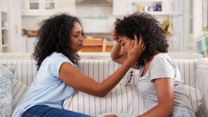 A mother consoles daughter with depression