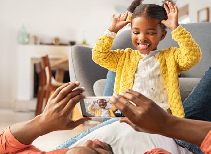 Smiling child records a video