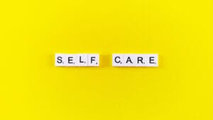 Scrabble letters spelling out "self care"