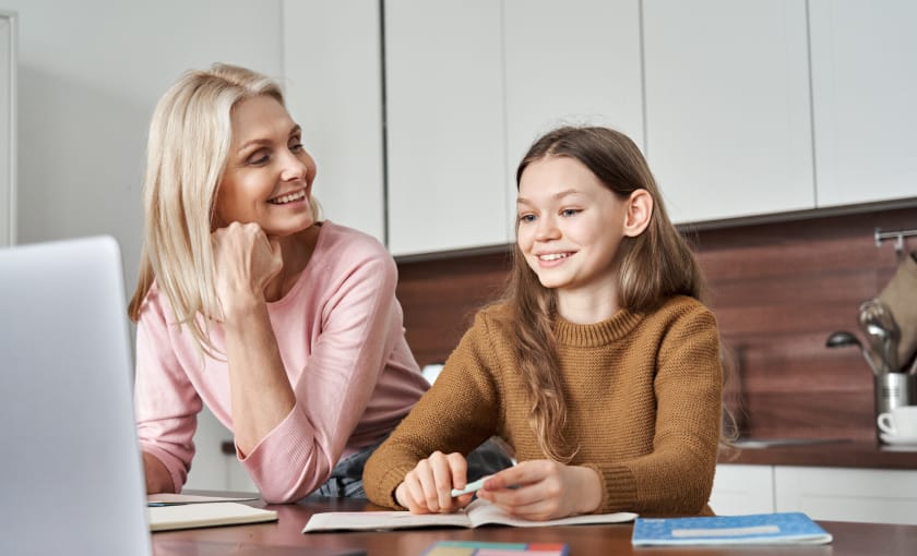 Mother and daughter work together on a computer