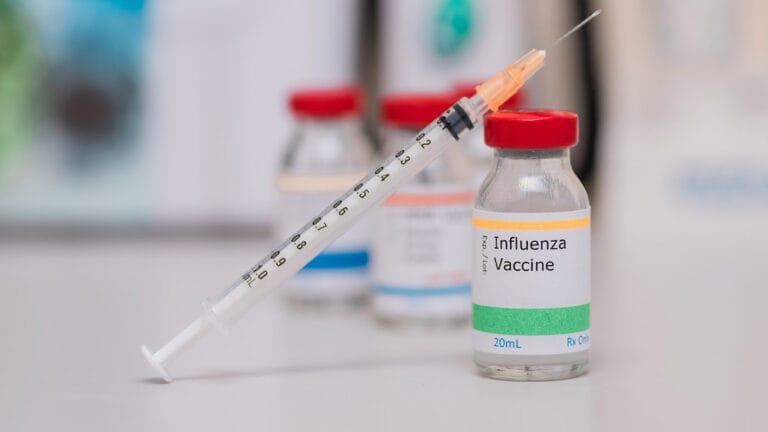 Photo of the influenza vaccine and syringe