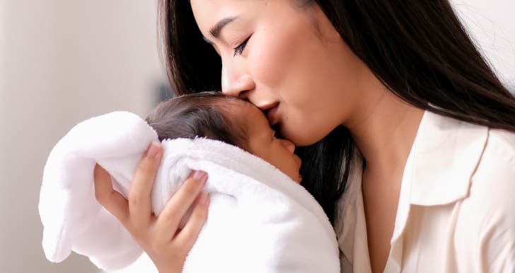 Mother kisses infant child