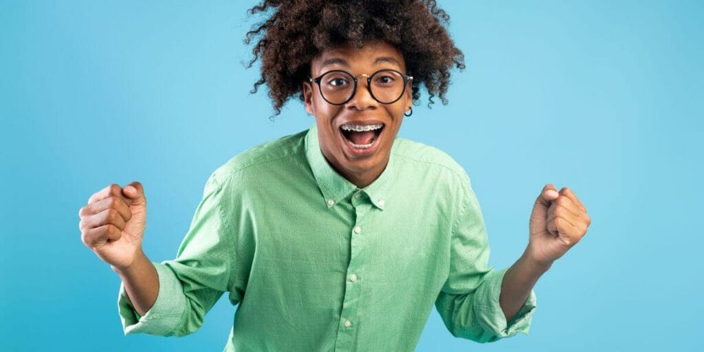 teen boy excited with braces on his teeth