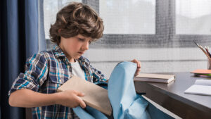 anxious child packing his backpack for school
