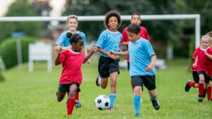 Kids playing soccer.