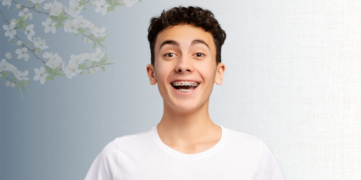 teen boy smiling with braces on