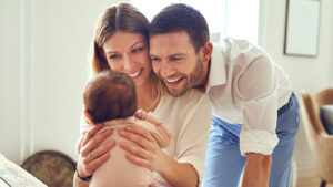 young mom and dad talking to a new baby