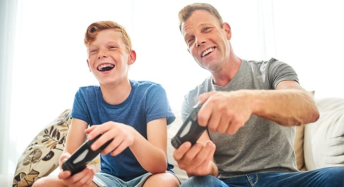 Teen with braces playing games with parent
