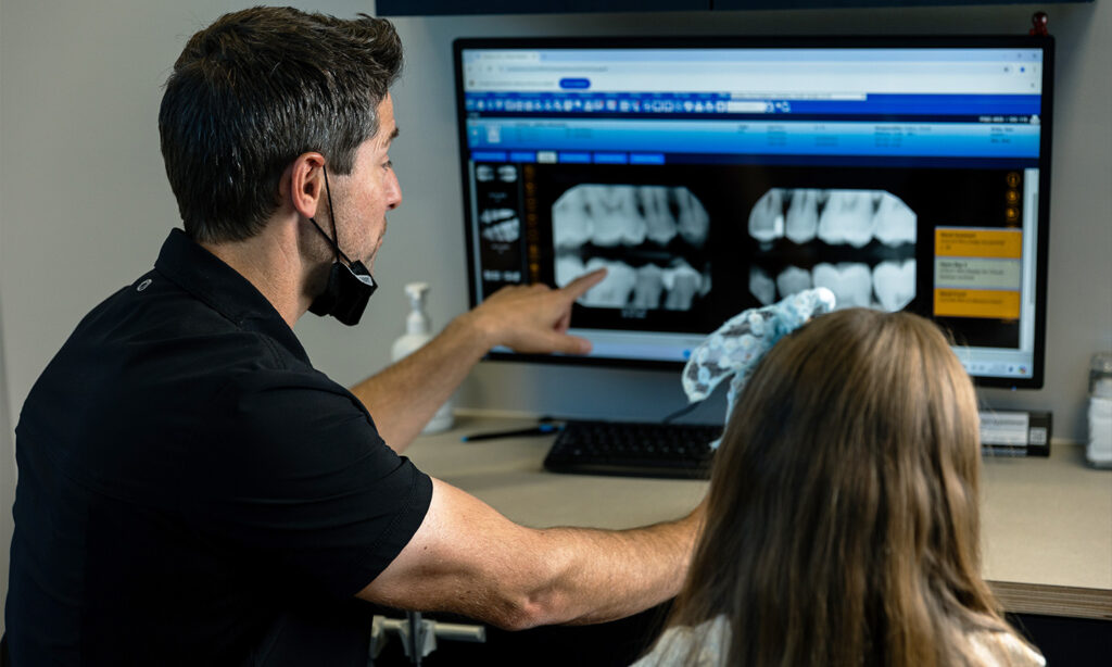 Pedatric dentist and patient review x-rays