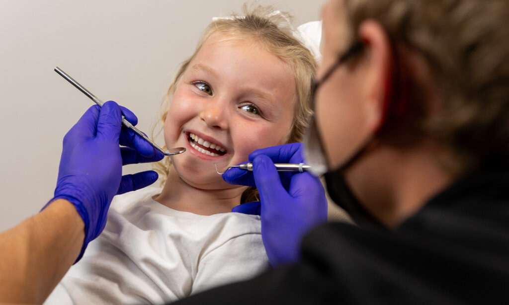 Smiling young patient at the dentist