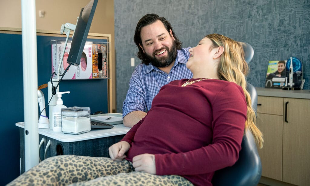 Casey Brewer, DMD, MSD smiles with an orthodontic patient