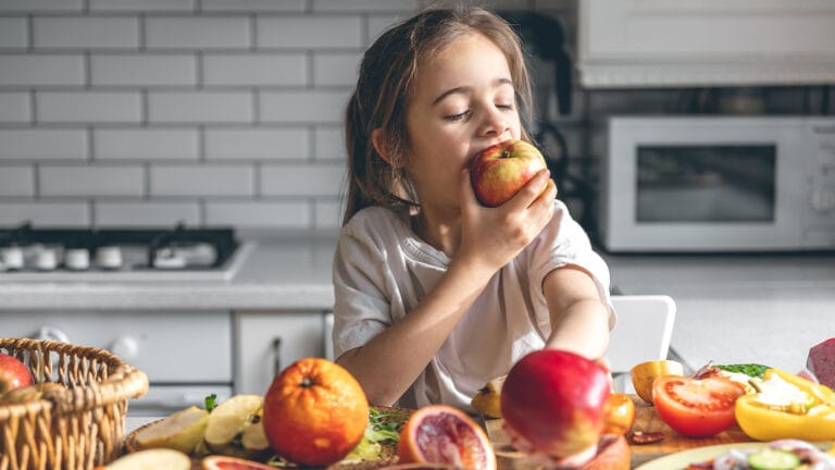 Young girl enjoying fruits and vegetables