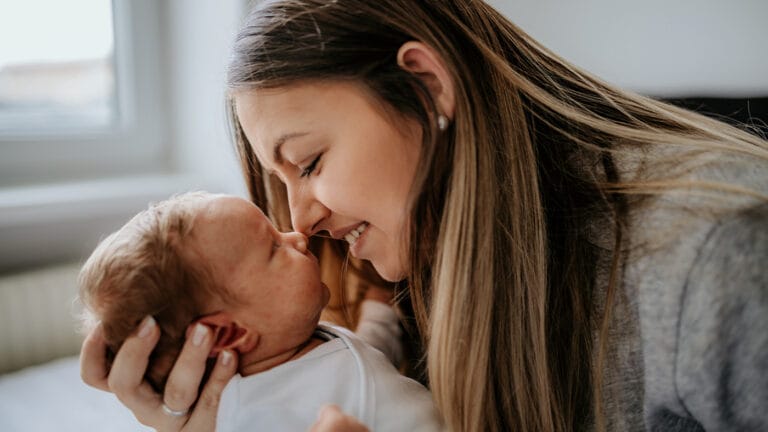 Mom caressing her baby with acne