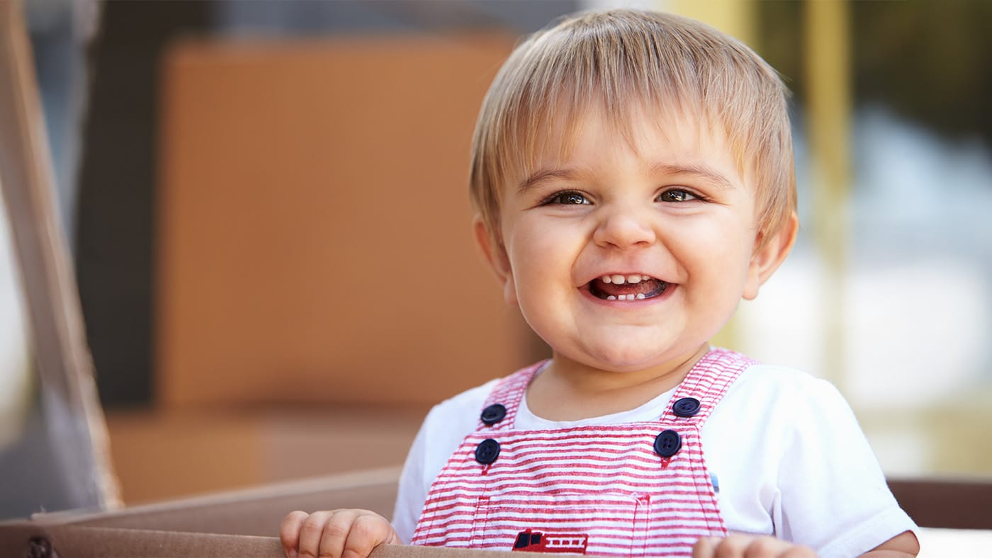 Young toddler flashing baby teeth