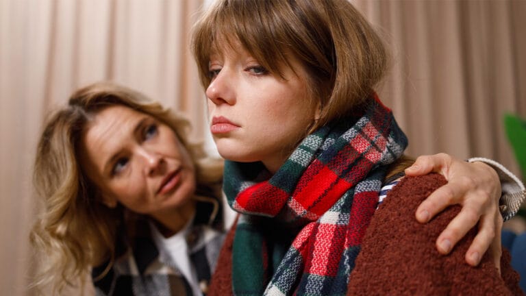 Mother consoling deeply upset daughter