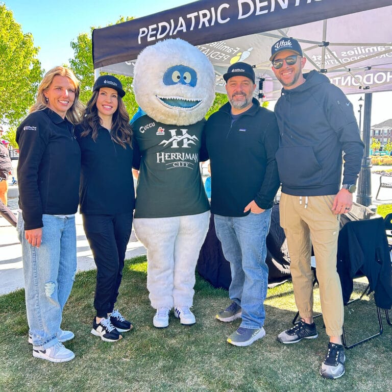 Families First Pediatrics providers smiling with Herriman's mascot