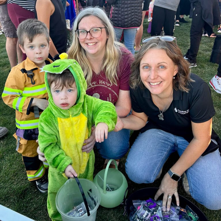 Smiling provider with children in costume