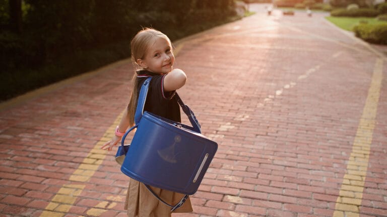 Young girl heading to first day of school in her uniform