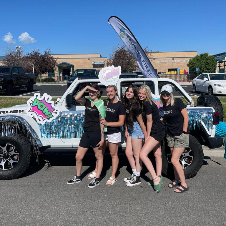 Families First Pediatrics team with a Jeep at Herriman