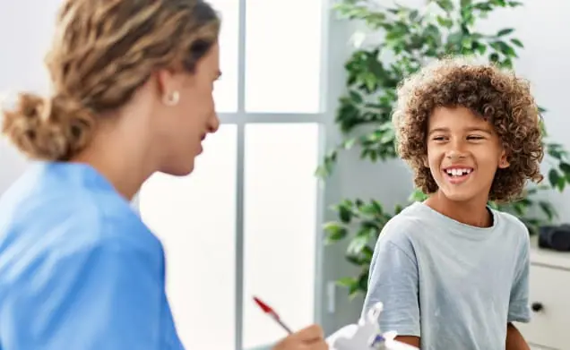 Happy child smiles at their pediatrician