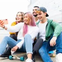 A group of co-ed teens taking a happy selfie