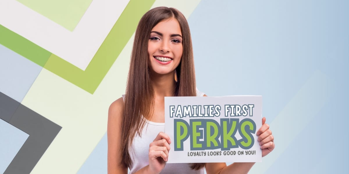 teen girl smiling holding sign for Families First Perks