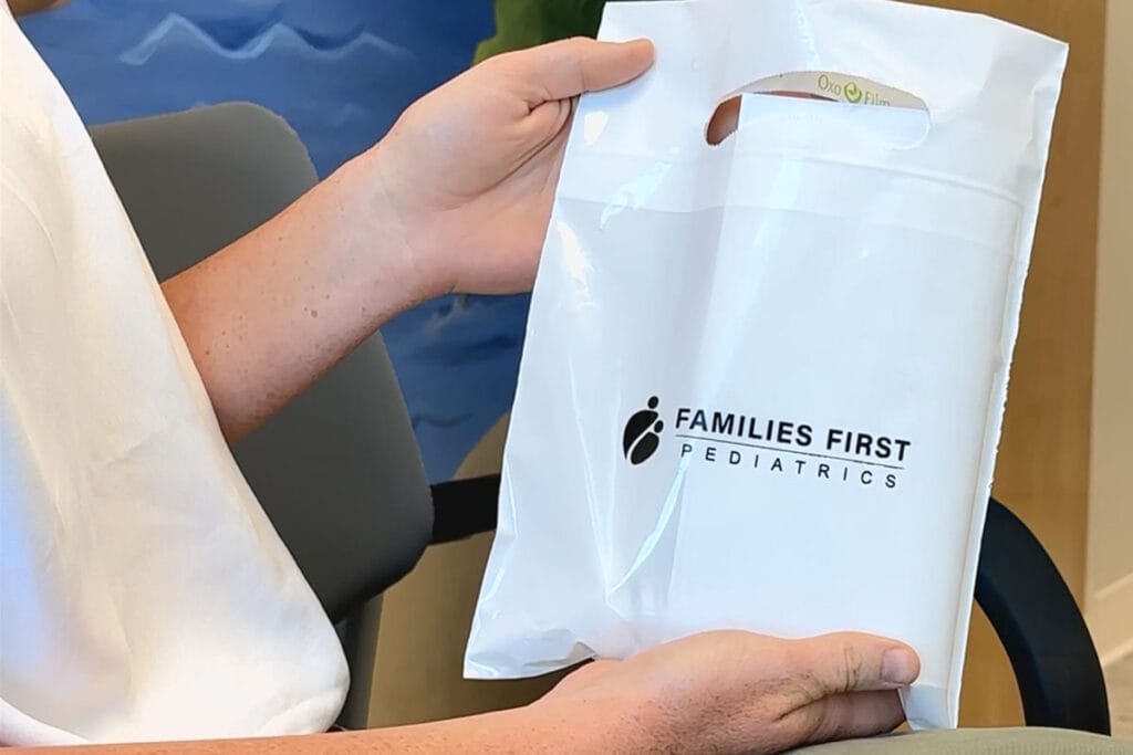 Mother collecting her child's prescriptions at their appointment
