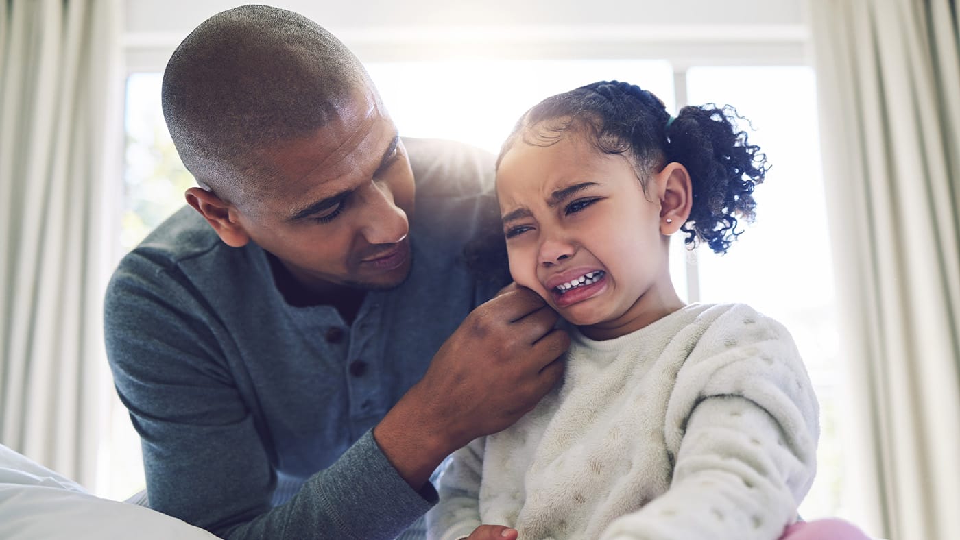 Father consoling daughter