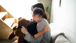 A mother consoling her son