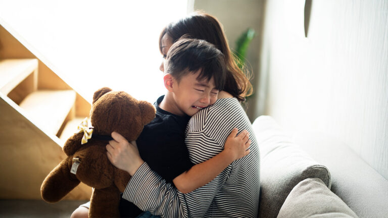 A mother consoling her son