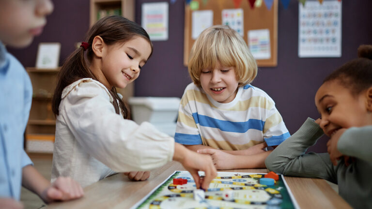 group of kids playing a boardgame