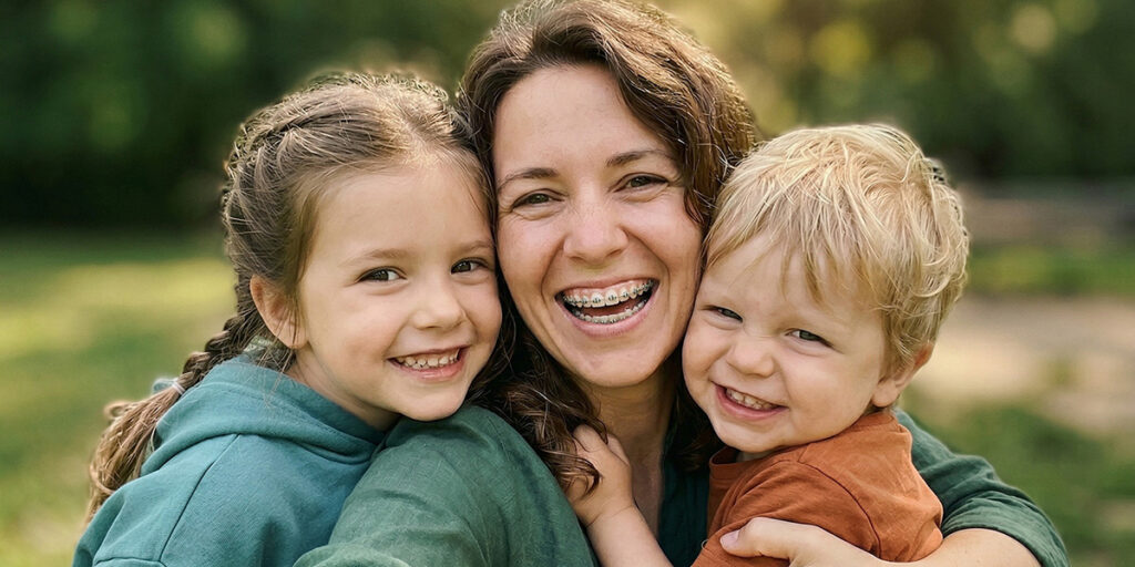 Smiling mom, daughter, and son.