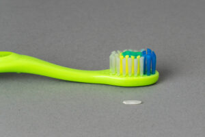 toothbrush with a rice grain amount of toothpaste
