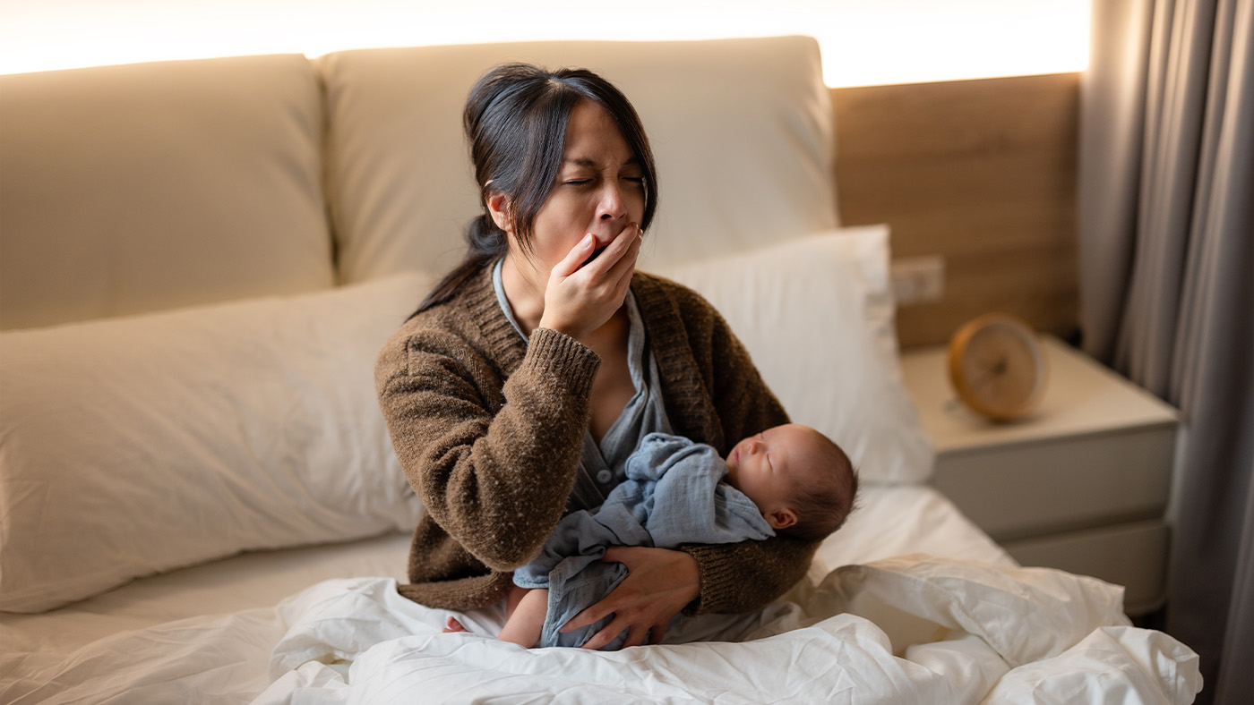Mother with newborn yawning