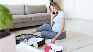 Pregnant woman packing a luggage for her hospital stay