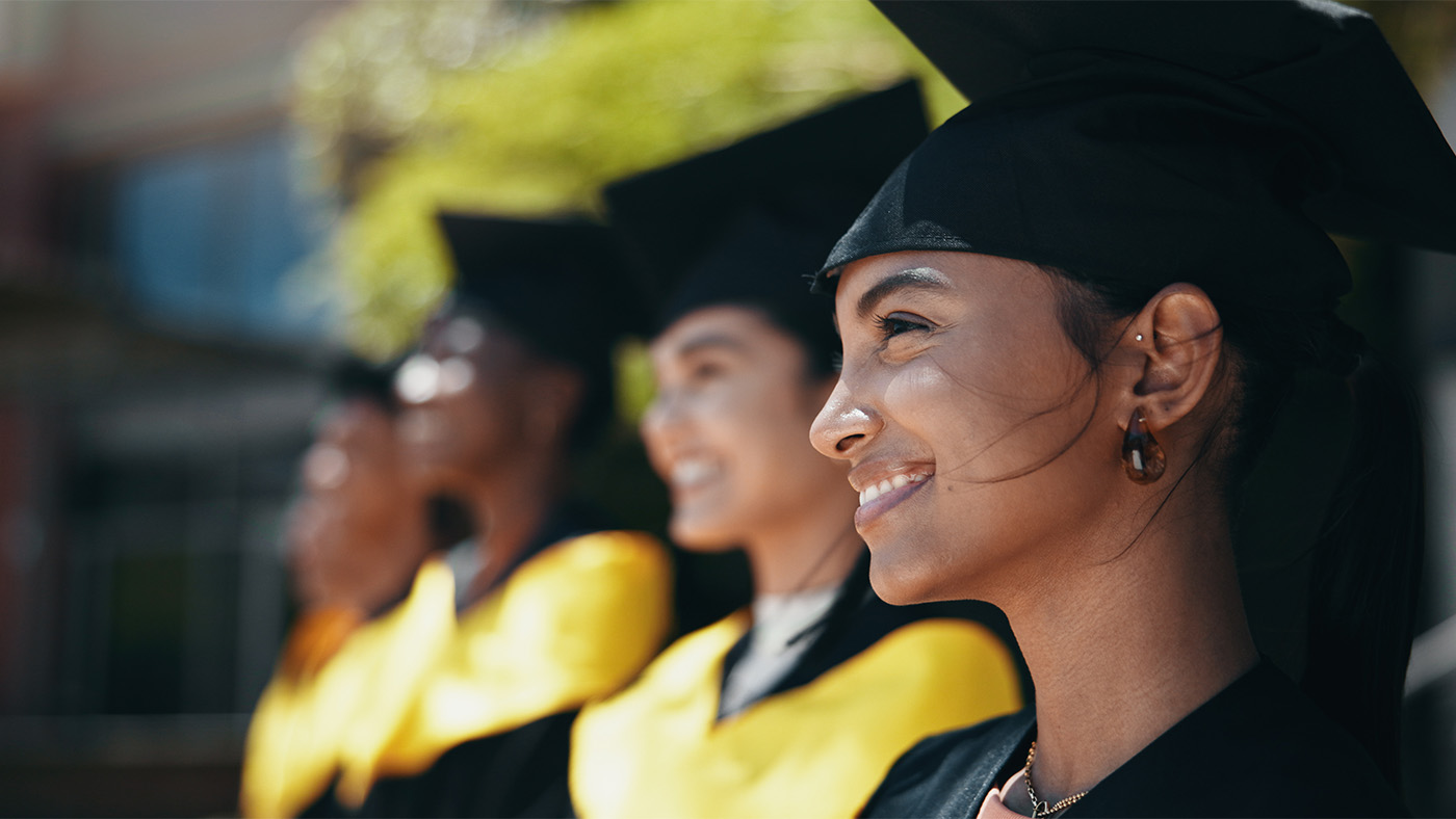 A row of high school graduates wearing their cap and gown
