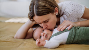 A mother kissing her baby
